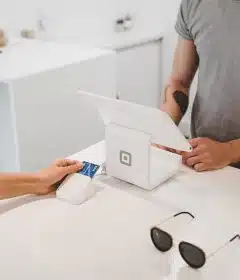 person using white tablet computer on table